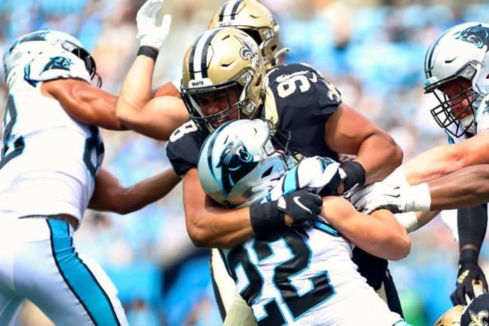Saints DE Payton Turner (98) wraps up Panthers RB Christian McCaffrey (22) for a loss. Credit: Sports Illustrated